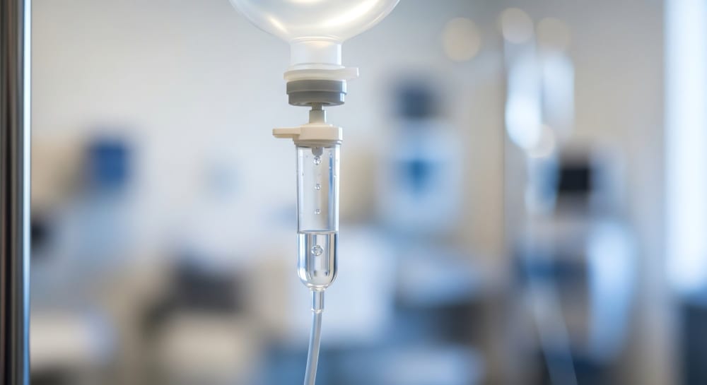 An IV drip bag and line in a treatment room