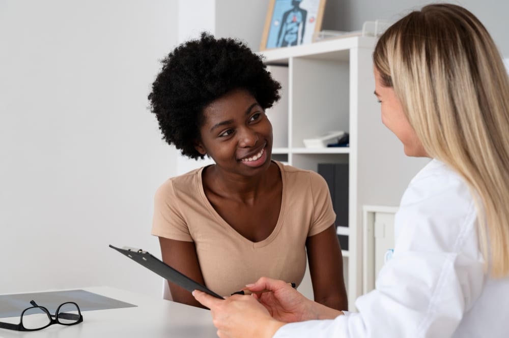A doctor talking with a patient during a women's health consultation